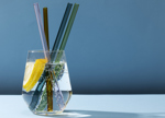 Transparent Glass With Fizzy Water And Colored Glass Straws